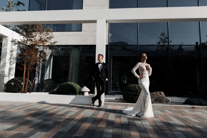 Happy young couple spends their honeymoon in a beautiful hotel traveling around Europe Fashion and glamorous wedding